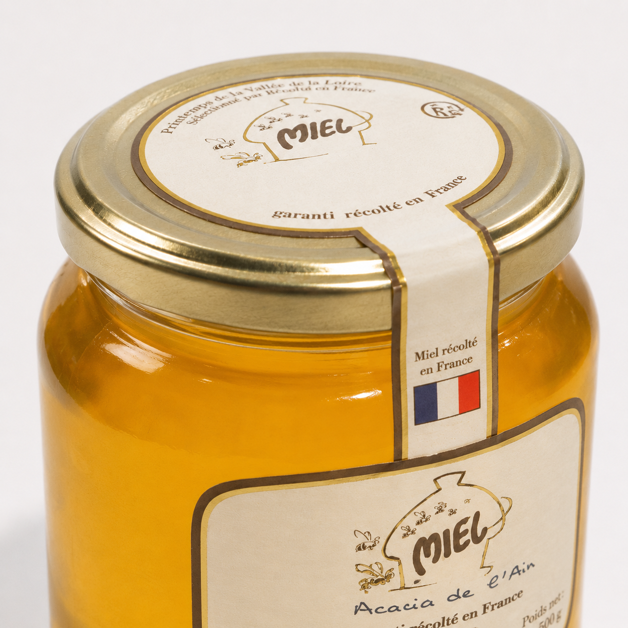 Etiquette du pot de miel d'acacia récolté dans le département de l'Ain